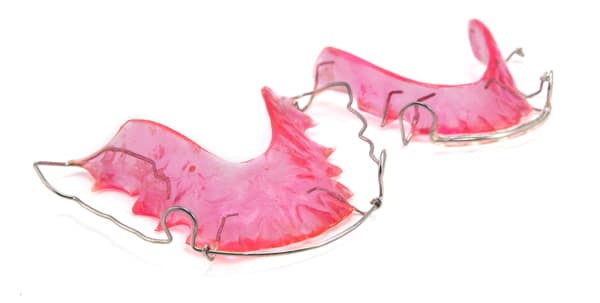 Hawley retainer with a front wire bar and molded acrylic plate